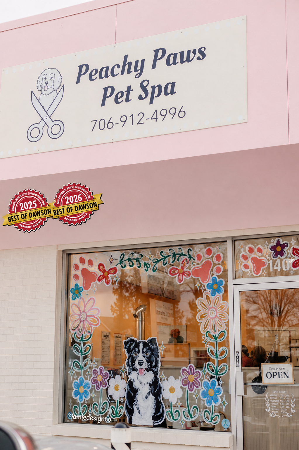 Peachy Paws Pet Spa storefront with pink facade, floral window art and Best of Dawson badges